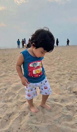 A boy dancing on the sandy beach image