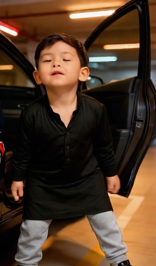 Baby boy holding car door - underground garage - baby dance image
